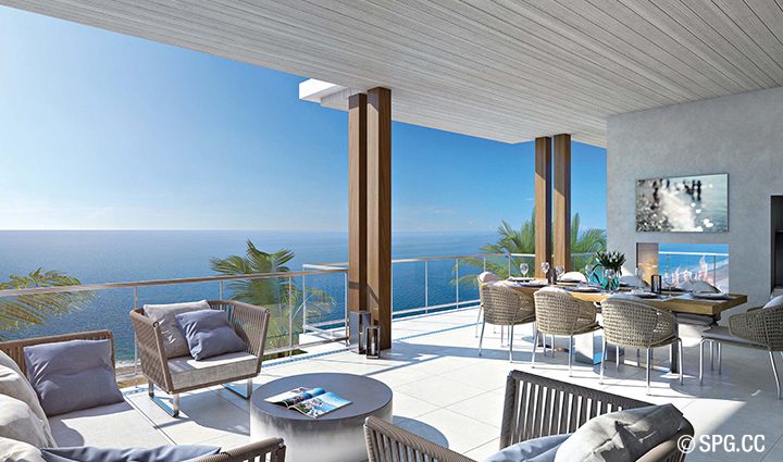 A great room spills out to a generous terrace with a built-in linear fireplace, summer kitchen and glass railing for unobstructed ocean views.